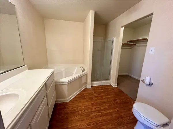 a bathroom with a sink a toilet a tub and shower