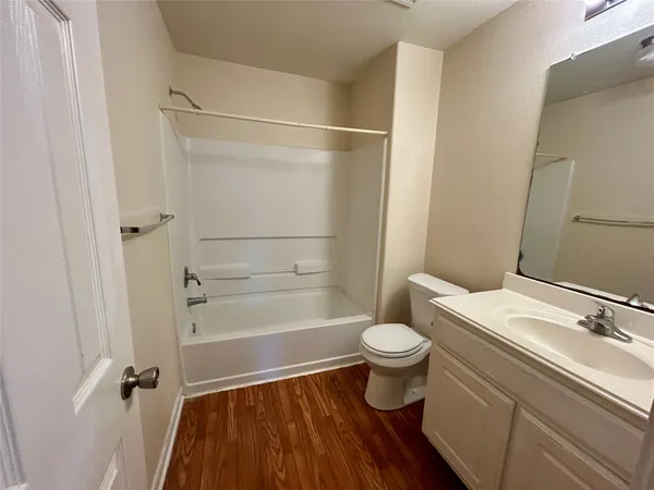 a bathroom with a sink a toilet a shower and a mirror