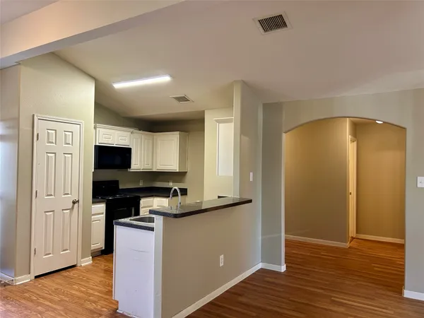 a kitchen with a refrigerator and a stove top oven