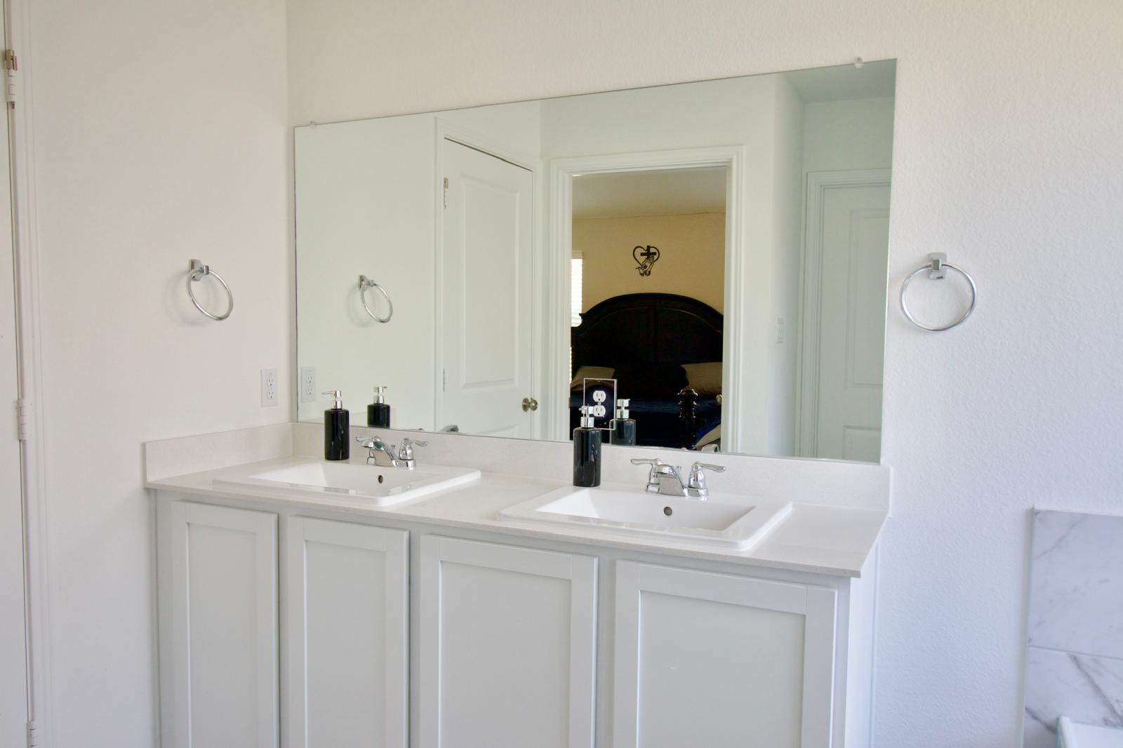 2545 Four Waters Loop Georgetown, TX 78628 - Photo 11 of 14 Clean lines and a spacious double vanity elevate this contemporary bathroom space.