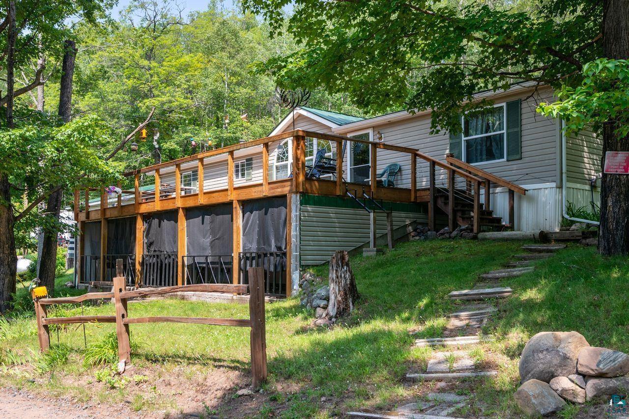9505 Wildwood Campground Road Iron River, WI 54847 - Photo 2 of 34 Back of house featuring a lawn and a deck