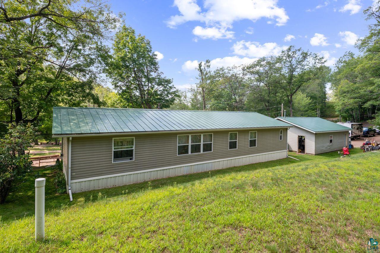 9505 Wildwood Campground Road Iron River, WI 54847 - Photo 21 of 34 Back of house with a yard