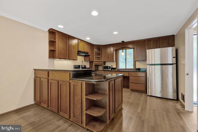 19621 Sparr Spring Road Montgomery Village, MD 20886 - Photo 14 of 18 a kitchen with a refrigerator a stove top oven a sink and cabinets