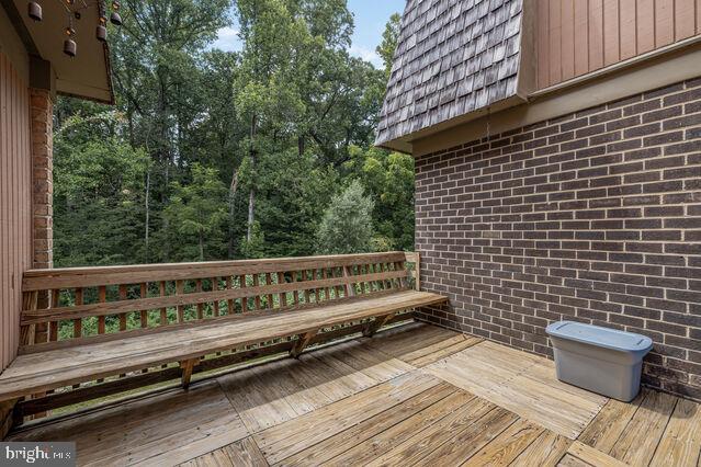 19621 Sparr Spring Road Montgomery Village, MD 20886 - Photo 9 of 18 a view of a wooden bench sitting on roof