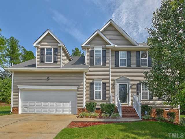 8008 Mill Bluff Court Raleigh, NC 27616 - Photo 1 of 25 a front view of a house with a yard and garage