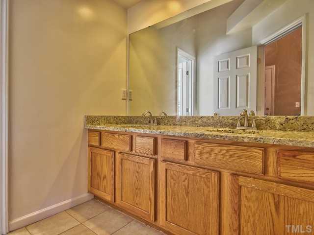 8008 Mill Bluff Court Raleigh, NC 27616 - Photo 18 of 25 a bathroom with a sink and a mirror