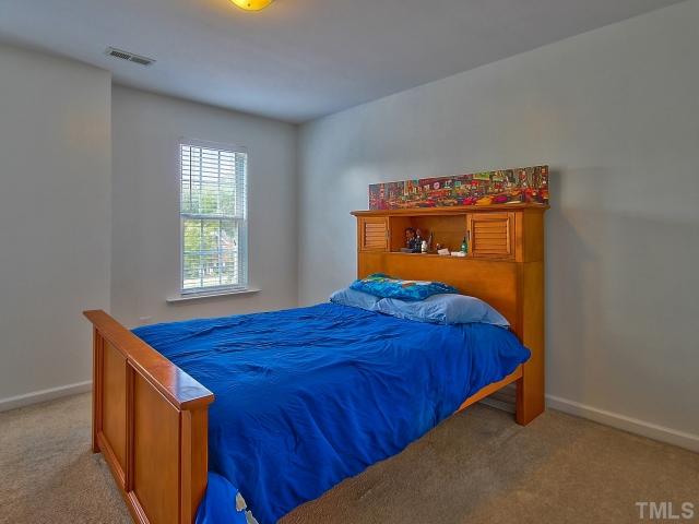 8008 Mill Bluff Court Raleigh, NC 27616 - Photo 20 of 25 a bedroom with a bed and window