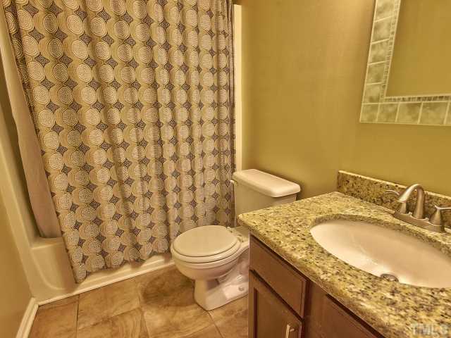 8008 Mill Bluff Court Raleigh, NC 27616 - Photo 21 of 25 a bathroom with a granite countertop toilet and a sink