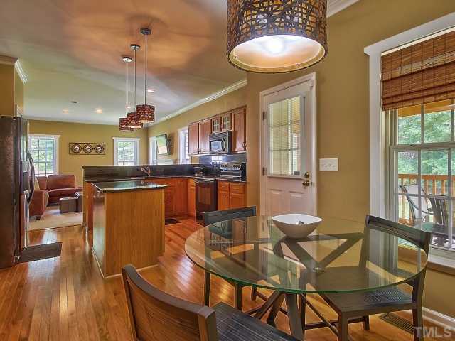 8008 Mill Bluff Court Raleigh, NC 27616 - Photo 8 of 25 a dining room with furniture and wooden floor