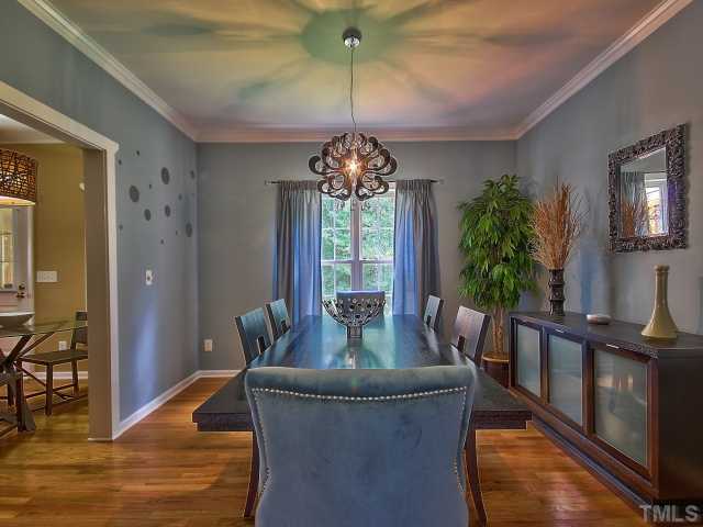 8008 Mill Bluff Court Raleigh, NC 27616 - Photo 10 of 25 a dining room with furniture potted plants and wooden floor