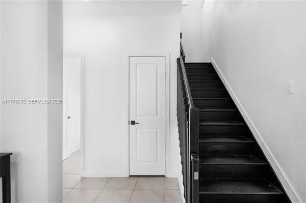 a view of a hallway with wooden floor and entryway