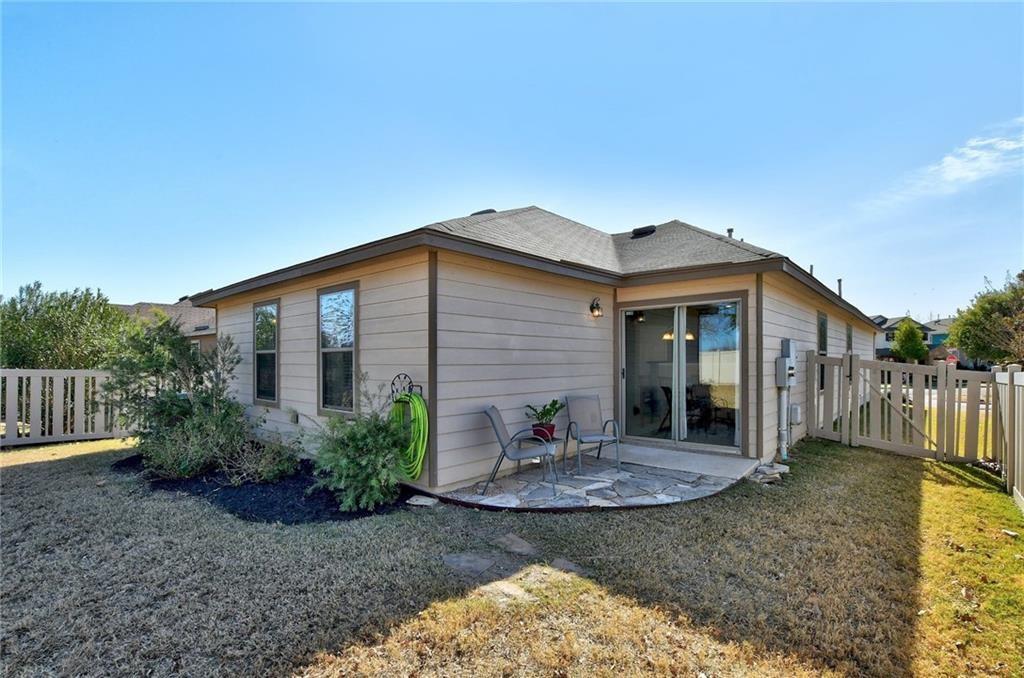 201 Edwin Kyle, TX 78640 - Photo 20 of 21 Rear exterior featuring a sliding glass patio door, a flagstone patio, and a privacy fence
