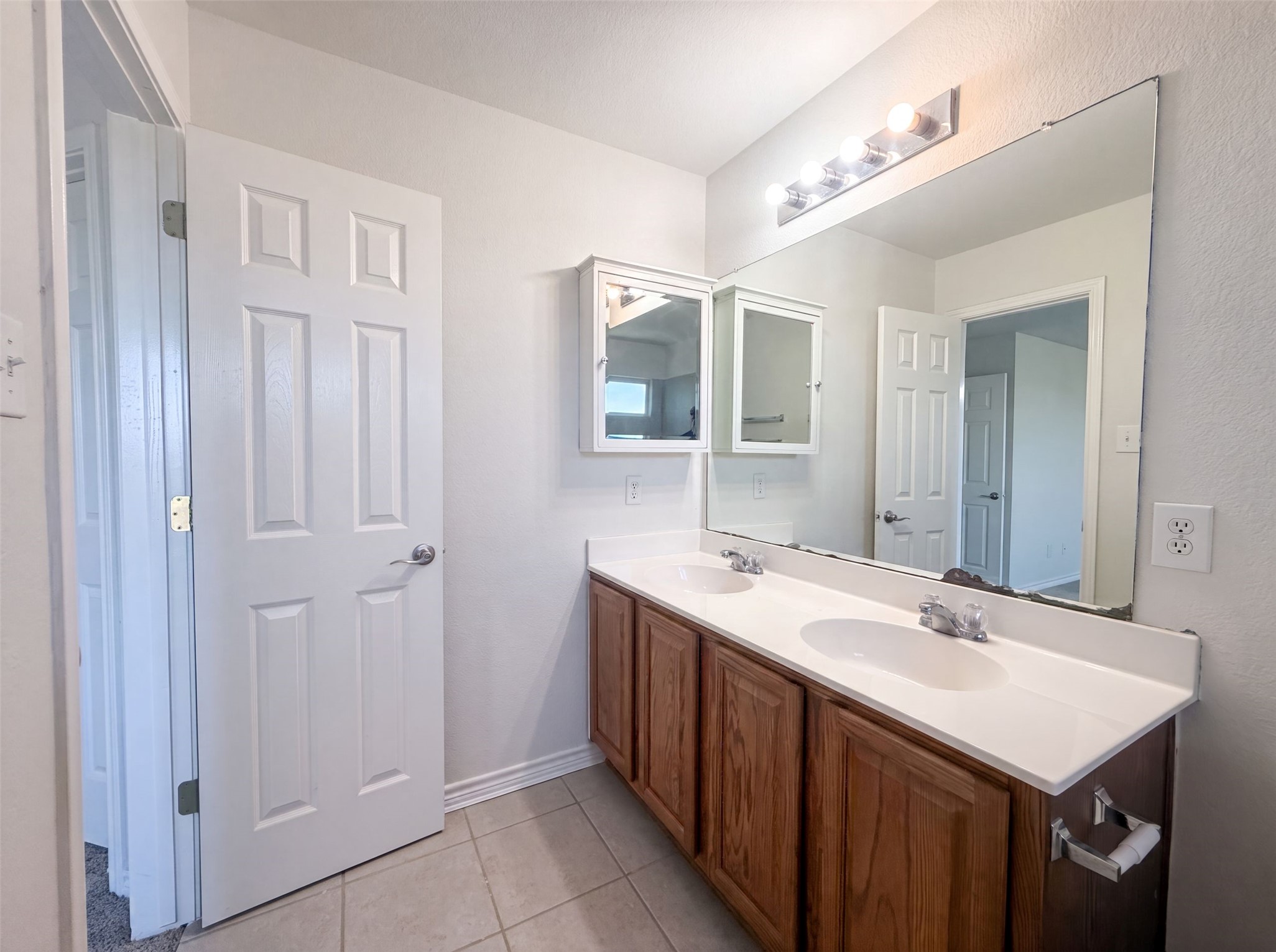 40 Verde Ranch Loop Leander, TX 78641 - Photo 16 of 20 Double vanity with ample storage and bright lighting, perfect for daily routines.