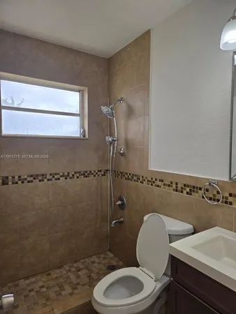 a bathroom with a toilet a sink and shower