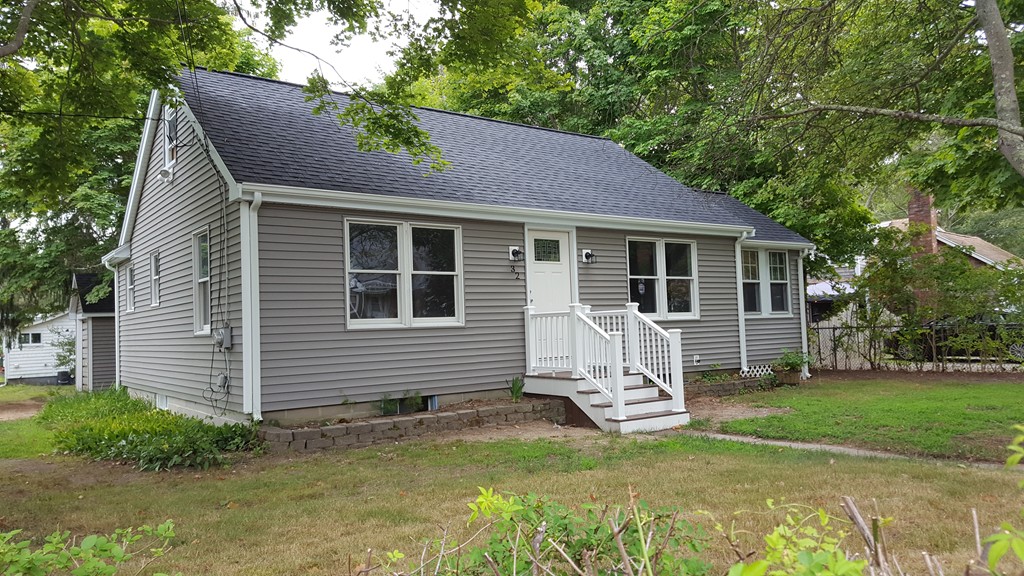 a view of a house with a yard patio and a garden