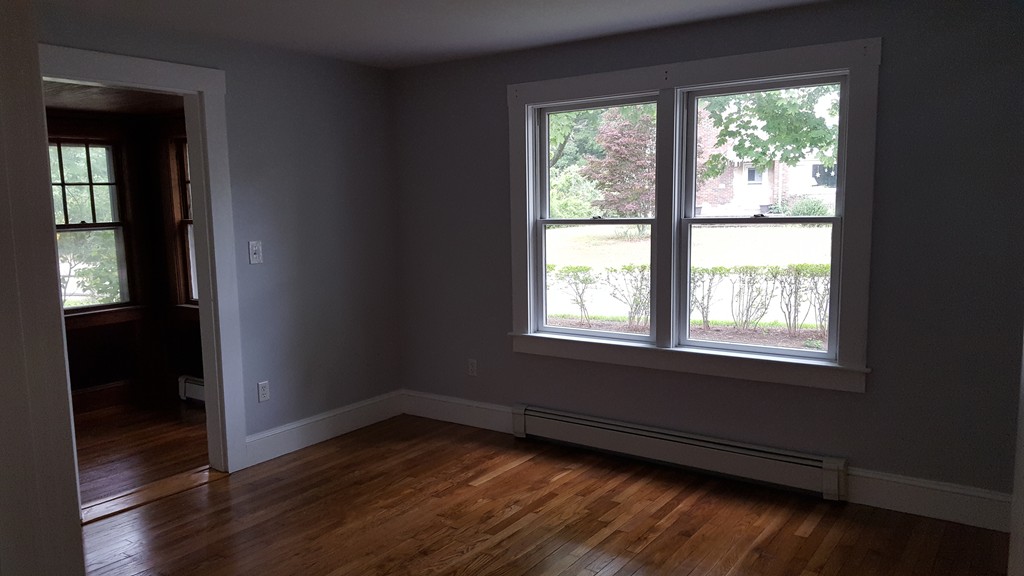 32 Puritan Road Bourne, MA 02532 - Photo 8 of 10 an empty room with wooden floor and windows