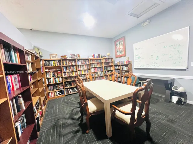 a dining room with furniture and a book shelf
