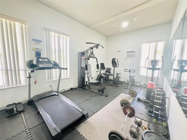 a room with gym equipment and a large window