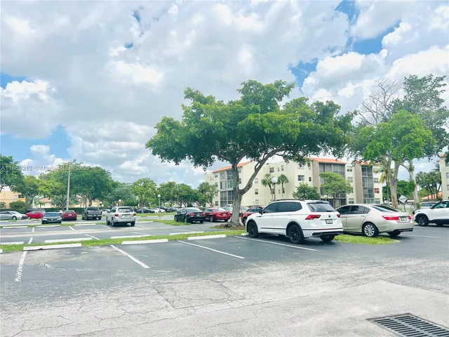a view of cars parked on the side of a street