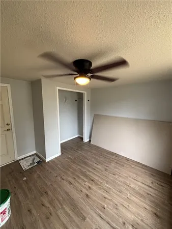 a view of a livingroom with a hall and wooden floor