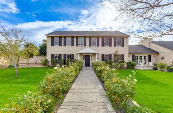 a front view of house with yard and green space