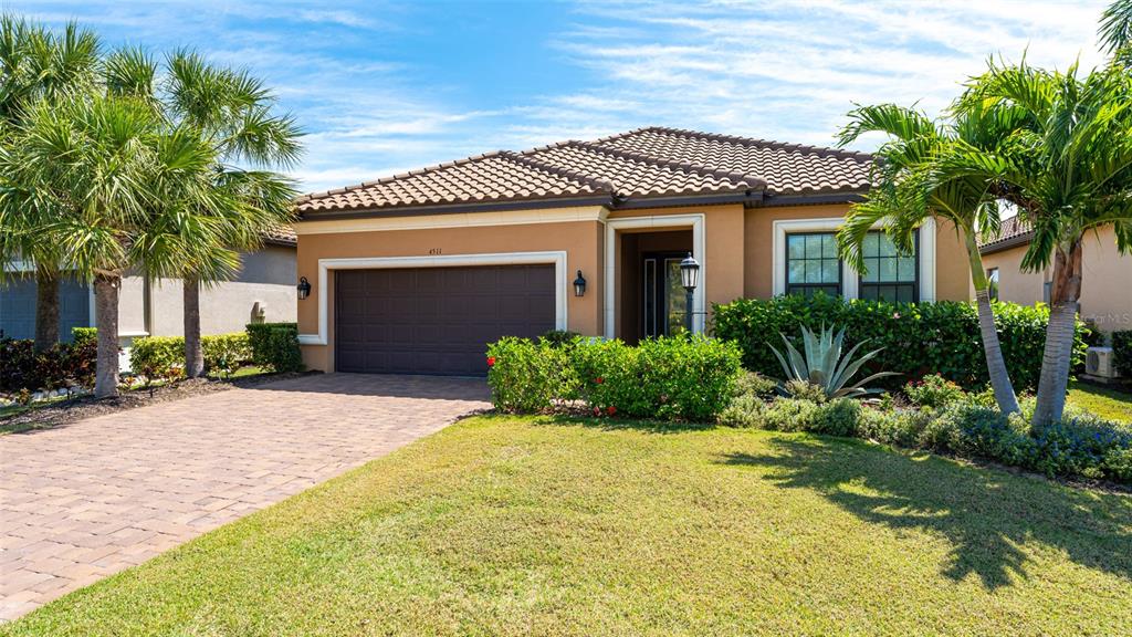 4511 Terrazza Court Lakewood Ranch, FL 34211 - Photo 34 of 65 a front view of a house with a yard and garage