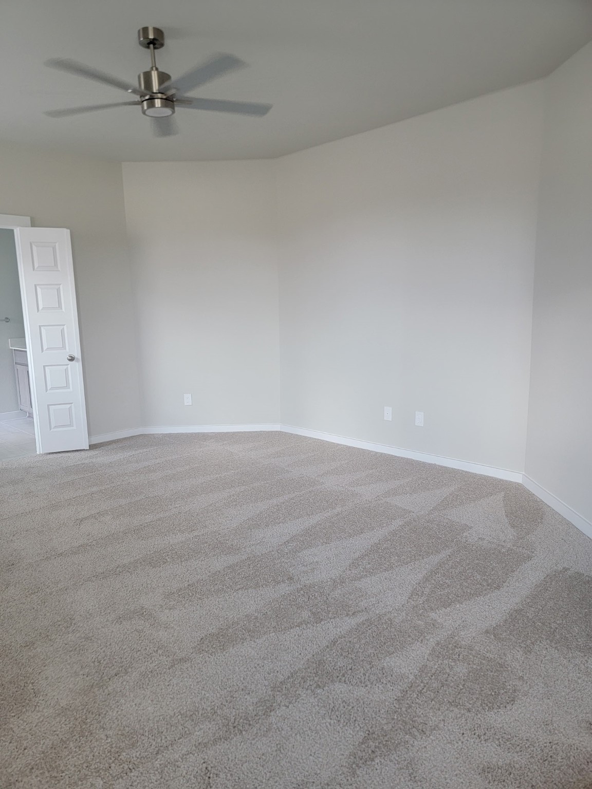 3130 Boulder Ridge Drive Rosenberg, TX 77471 - Photo 15 of 32 an empty room with a ceiling fan and carpet