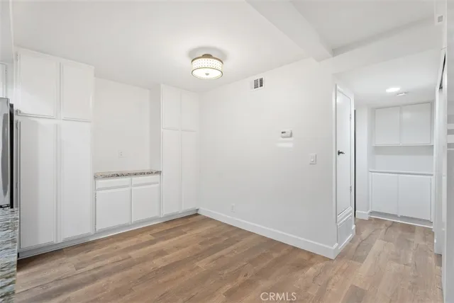 an empty room with wooden floor