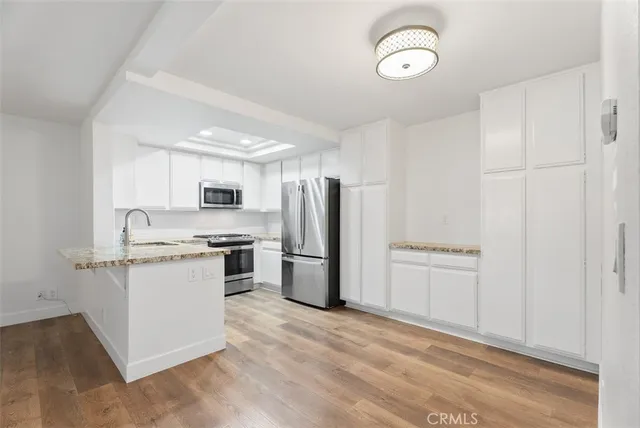 a kitchen with a refrigerator a sink and dishwasher