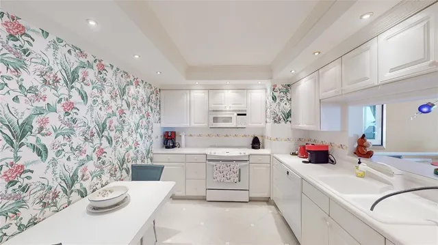 a kitchen with a sink a stove and cabinets
