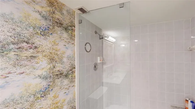 a bathroom with a shower and a mirror