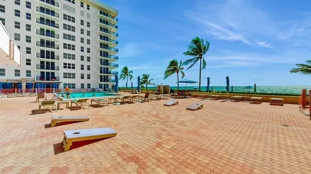 a view of a swimming pool with outdoor seating