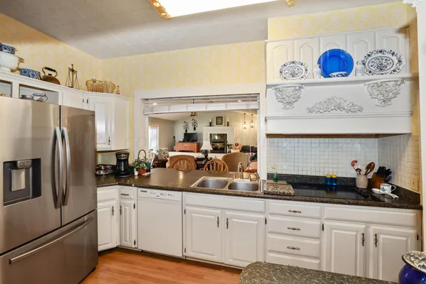 a living room with furniture fireplace and wooden floor