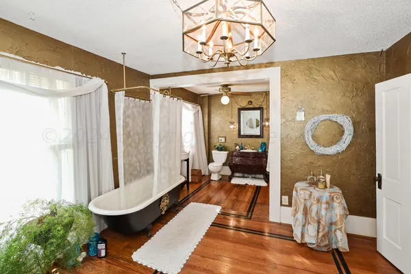 a spacious bathroom with a double vanity sink a toilet and a shower