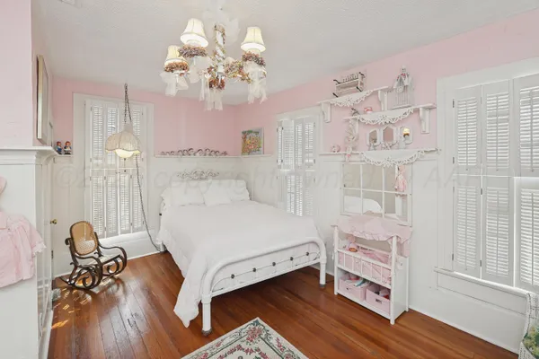 a tree in front of a white house