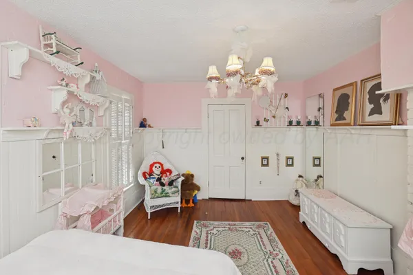 a backyard of a house with chairs and wooden fence