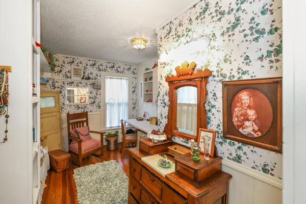 a backyard of a house with chairs and wooden fence