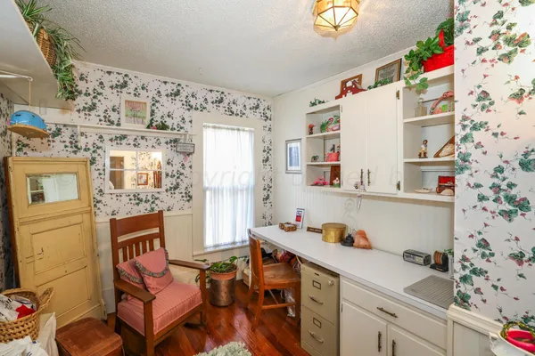 a front view of a house with plants and trees