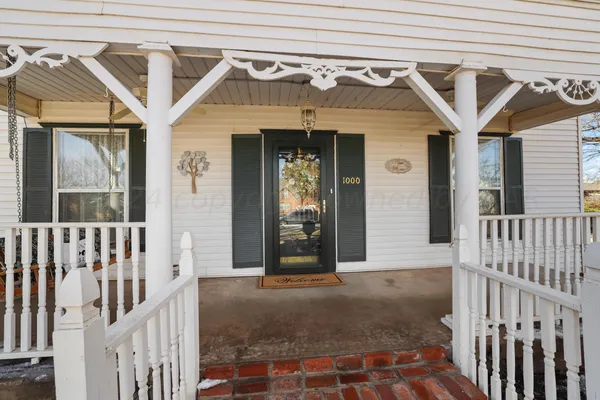a view of a house with a tree in the background