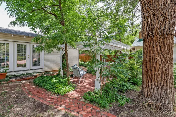 a living room with furniture a chandelier and a fireplace
