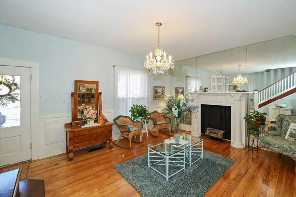 a view of a dining room with furniture wooden floor and chandelier