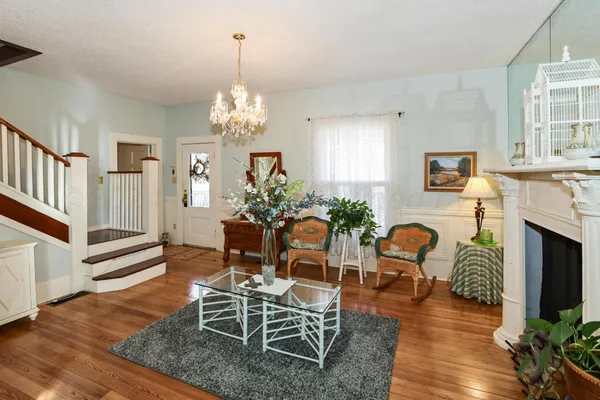 a view of a workspace with furniture and wooden floor