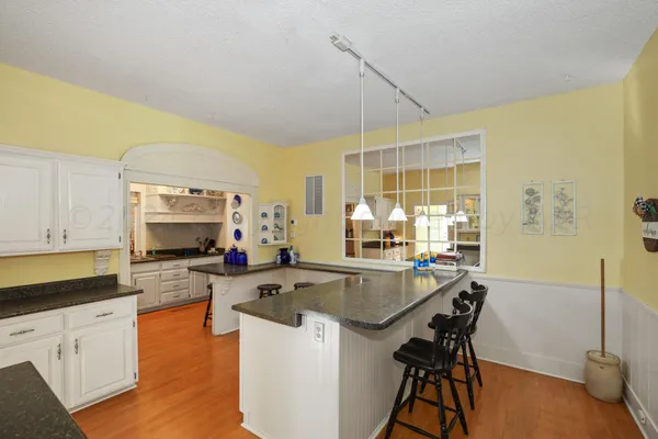 a view of a dining room with furniture wooden floor and a chandelier
