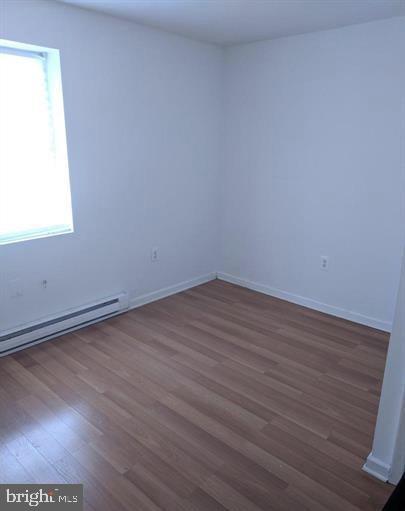 1201 South 13th Street, Unit A Philadelphia, PA 19147 - Photo 13 of 13 an empty room with wooden floor and windows