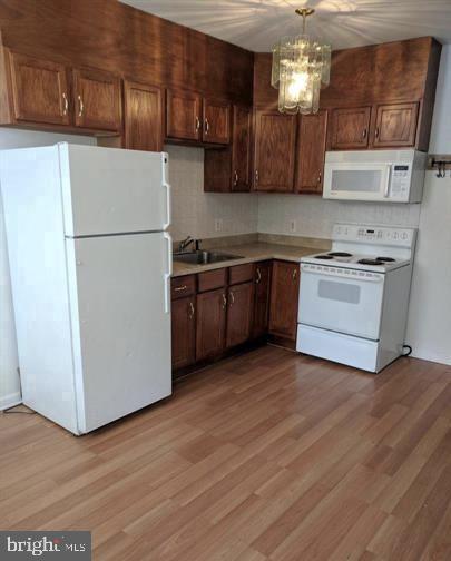 1201 South 13th Street, Unit A Philadelphia, PA 19147 - Photo 3 of 13 a kitchen with stainless steel appliances granite countertop a refrigerator a stove top oven a sink and dishwasher