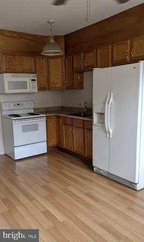 a kitchen with stainless steel appliances granite countertop a sink and a stove