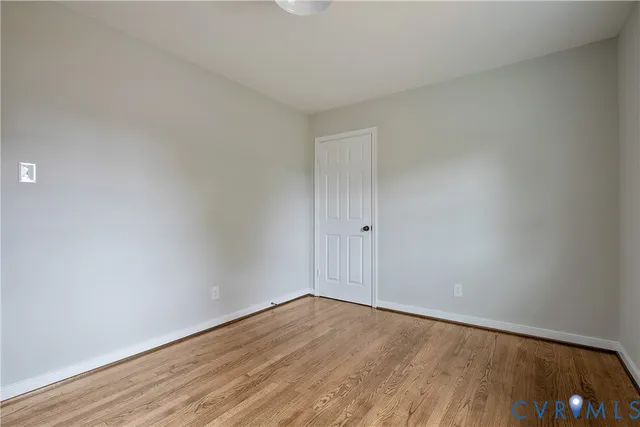 a view of an empty room and wooden floor