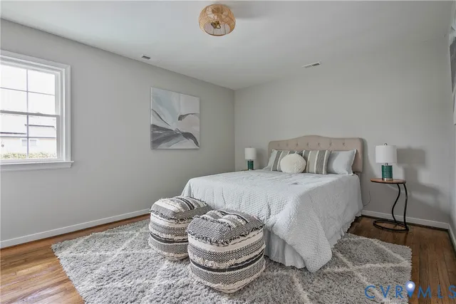 a bedroom with a bed and a chair