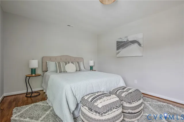 a bedroom with a bed and chair