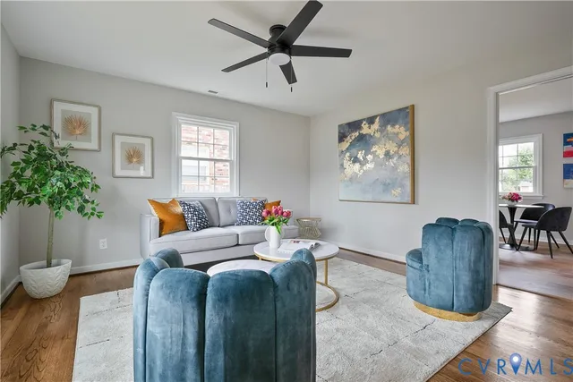 a living room with furniture a potted plant and a lamp